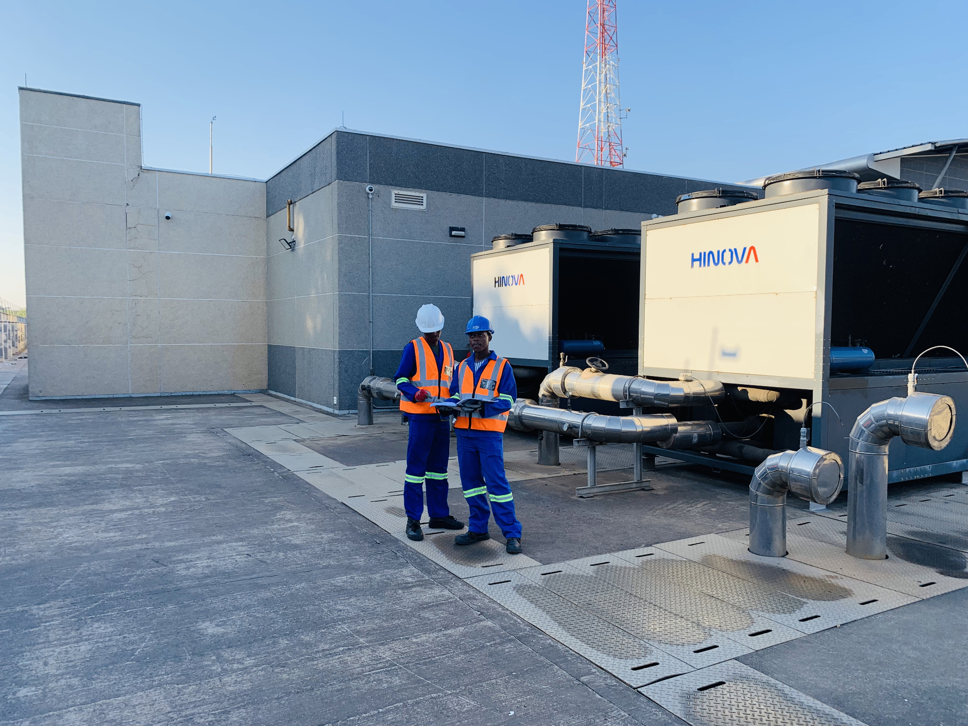 African Gray Infrastructure team reviewing HVAC equipment on site